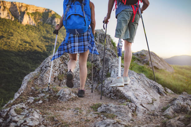istock Friends supporting each other climbing the mountain 962485210