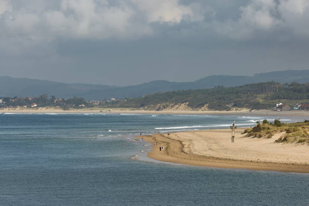 istock People enjoying a summer day on a beach in Santander, Spain 962485632