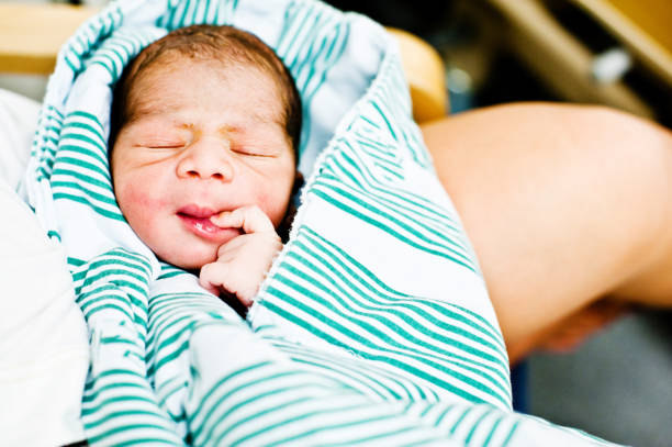 istock Child (New-born Baby) Doing The Thinking. Fingers On The Lips 962485642
