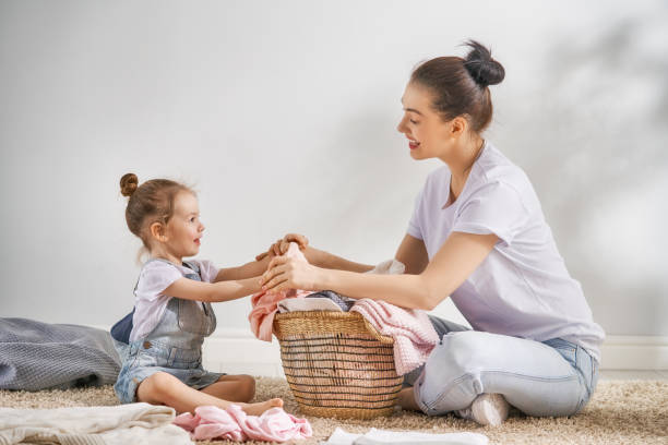 istock family doing laundry at home 962486176