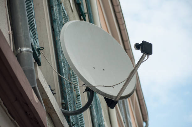 Satellite TV antenna on blue sky background