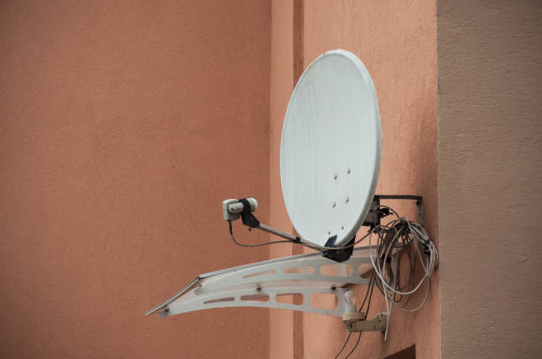 istock satellite antena on orange home facade 962486840