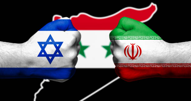 Flags of Israel and Iran painted on two clenched fists facing each other with map of Syriain the background/Israel - Iran conflict concept stock photo