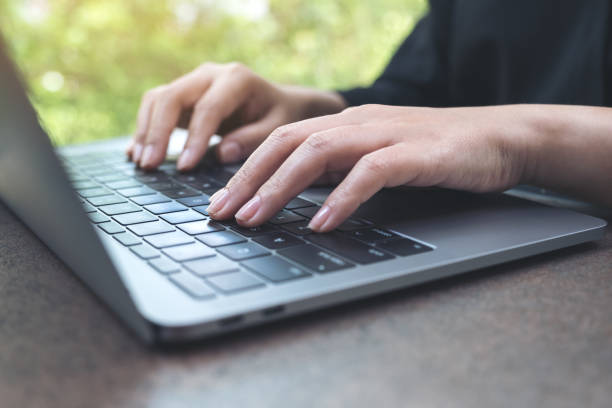 istock Closeup image of hands working and typing on laptop keyboard in office 962491446