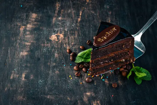 Sacher Chocolate Cake. On a wooden background. Top view. Copy space.