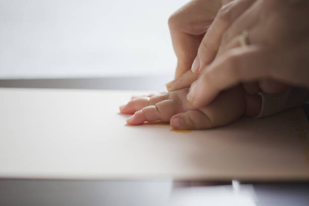 istock Mother making a hand print of baby 962496514