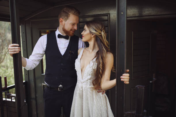 Bride and groom traveling by old train