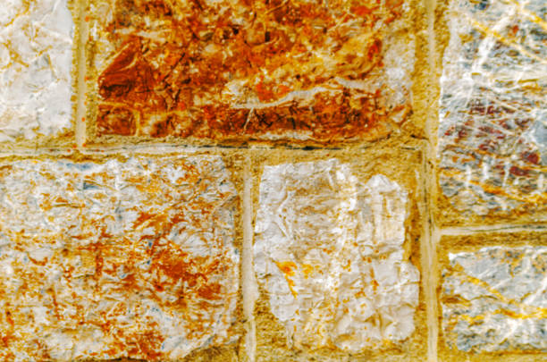 old stone placed in the wall, interesting and original background, solid wall