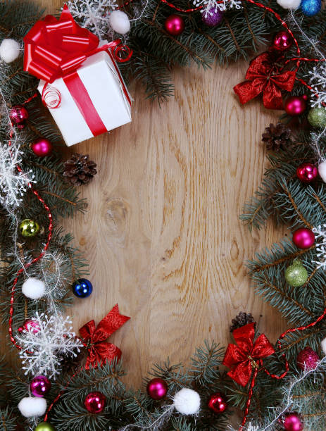 istock Christmas wreath and gift on wooden background 962503654
