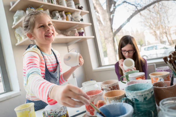 istock Happy girls at pottery workshop 962511798