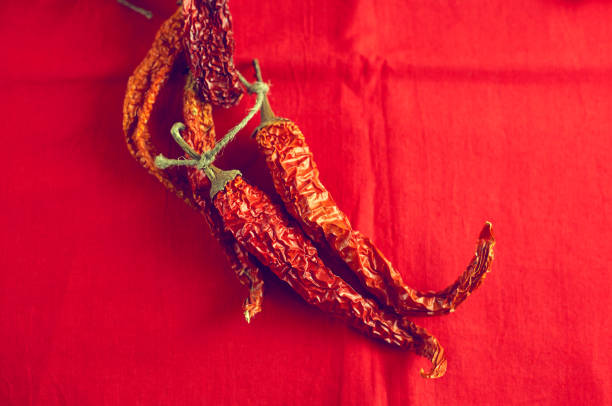 Dried red Bishop's Crown chilis with a distinctive shape and mild heat, perfect for enhancing salsas, sauces, and marinades.. Part of a food series.