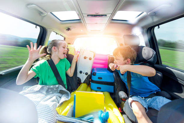 Siblings arguing in the car during a long car journey