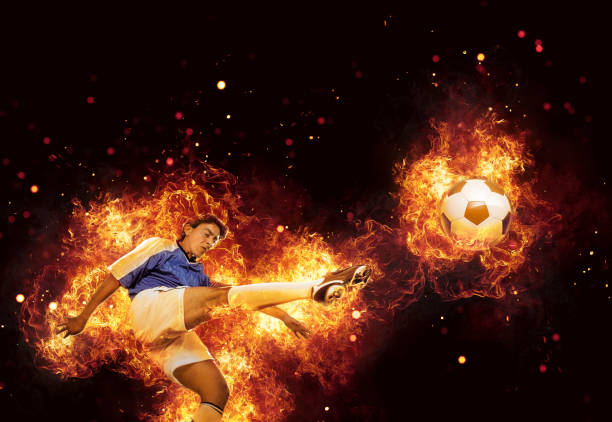 istock Best soccer player kicking ball surrounded by fire and flames 962528288