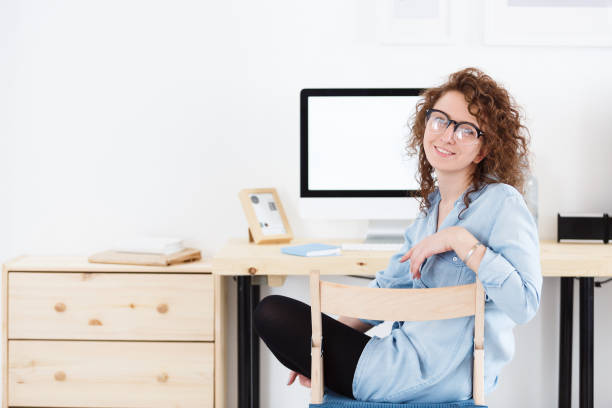 istock Happy and joyful European redhead student looking and smiling at the camera during small break. Education concept 962529120