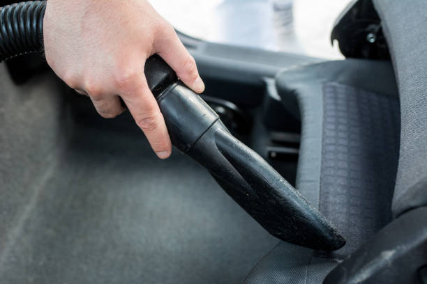 istock Man cleaning interior of his car 962532304