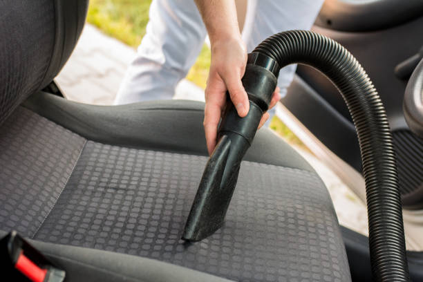 istock Man cleaning interior of his car 962532482