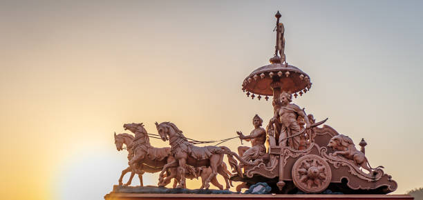 A statue of the Hindu god Krishna and his devotee Arjuna at Parmarth Niketan in Rishikesh, North India Best place to visit in rishikesh for inner peace of mind and soul chariot photos stock pictures, royalty-free photos & images