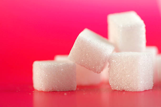 istock Pile of sugar cubes on pink background 96253468