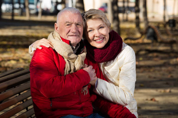 istock Mature couple sitting in park 962538080