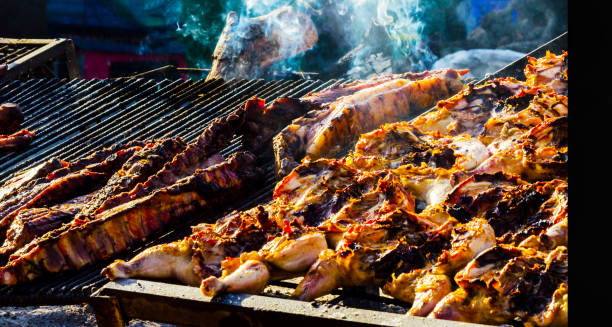 istock different types of meats and sausages stacked on a big grill while cooking 962538972