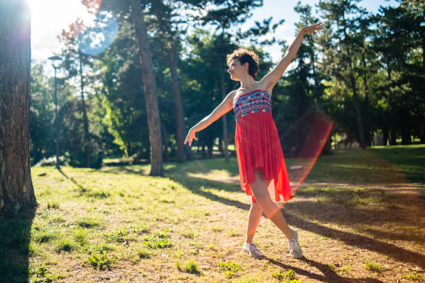 istock Woman dancing during sunny day outdoors 962539348