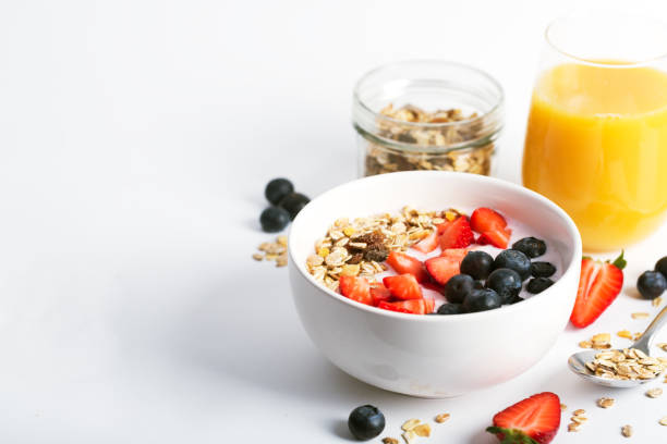 istock Smoothie bowl with yogurt, fresh berries and cereal. Isolated on white background 962546560