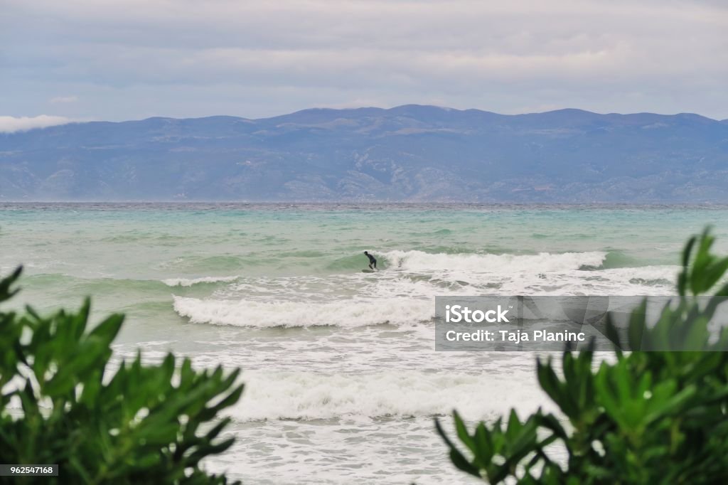 Young man surfing Adriatic sea / Mediterranean sea waves / cold water Absence Stock Photo