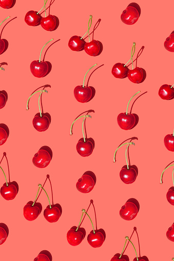 Cherry fruit isolated on red background