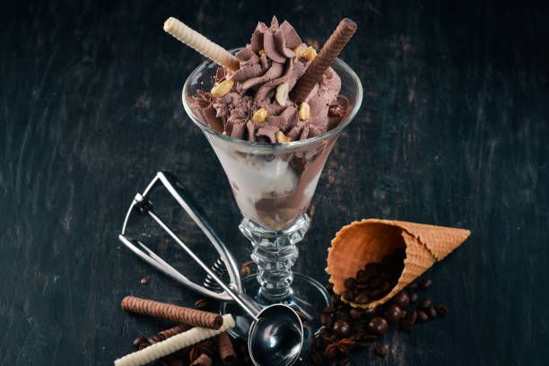 istock Chocolate ice cream with nuts. On a black wooden background. Copy space. 962552724