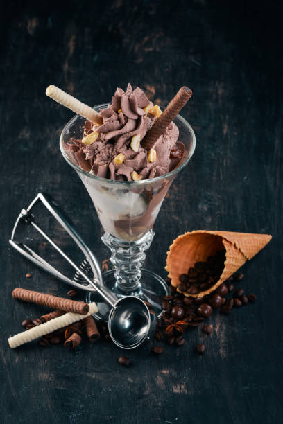 istock Chocolate ice cream with nuts. On a black wooden background. Copy space. 962553458