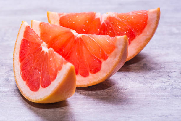 istock Grapefruit slices, juicy ripe isolated on a gray background 962556738