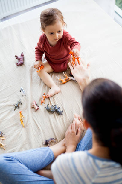 istock mother and daughter playing with toy animals 962556760