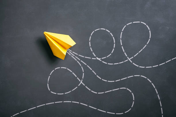istock Paper airplane on blackboard - Origami Yellow Concept 962558382