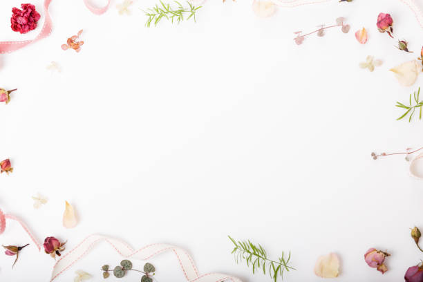 istock Festive flower composition on the white wooden background. Overhead view 962559470