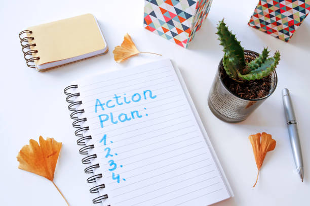action plan written in notebook - plan of action imagens e fotografias de stock