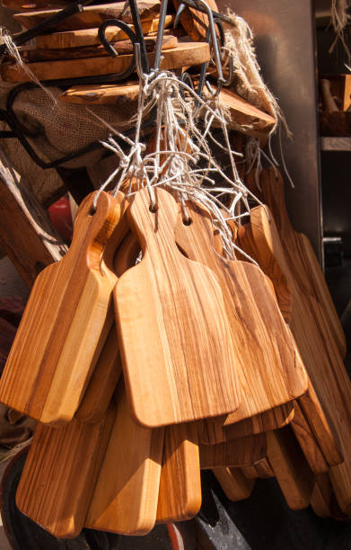 istock Many kitchen cutting boards in olive wood hung as souvenirs 962565222