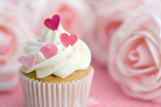 A valentine cupcake with hearts and roses