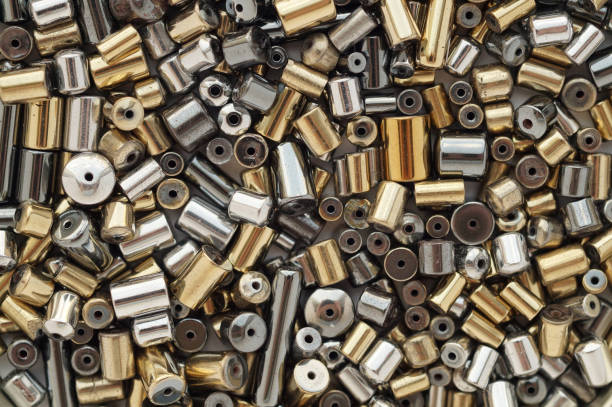 istock Shiny metallic hematite cylindrical beads background 962567574