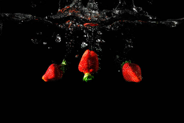 istock Strawberry in water black background 962569682
