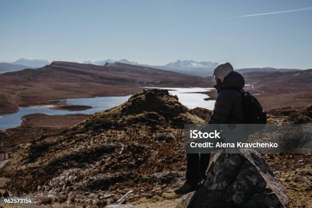 Man Relaxing On Top Of The Old Man Of Storr Walk On Isle Of Skye Scotalnd Sitting On A Stone Stock Photo - Download Image Now