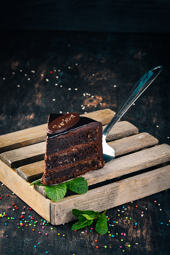 Sacher Chocolate Cake. On a wooden background. Top view. Copy space.
