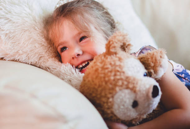 istock Cute girl hugging each other her teddy 962576958
