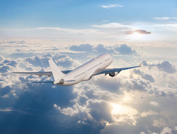 istock Passenger airplane flying above clouds at sunrise 962591012
