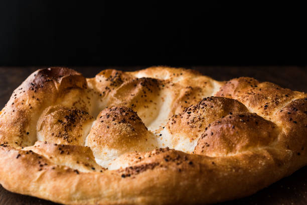 istock Turkish Ramadan Bread - Ramazan Pidesi on wooden surface / Pide 962596626
