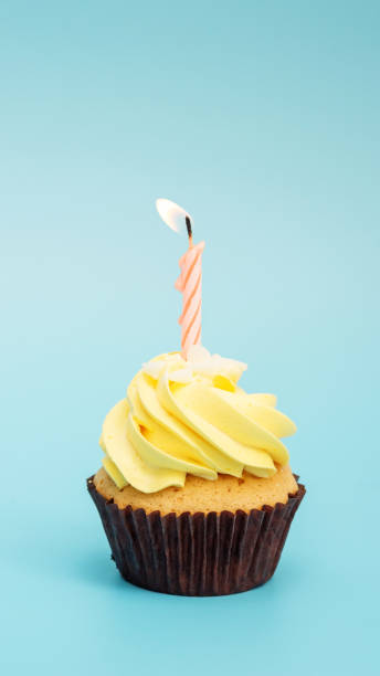istock Cupcake and candle on a blue background. 962598846