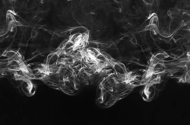 istock abstract beautiful fragment movement of burn white smoke on black background. 962598972