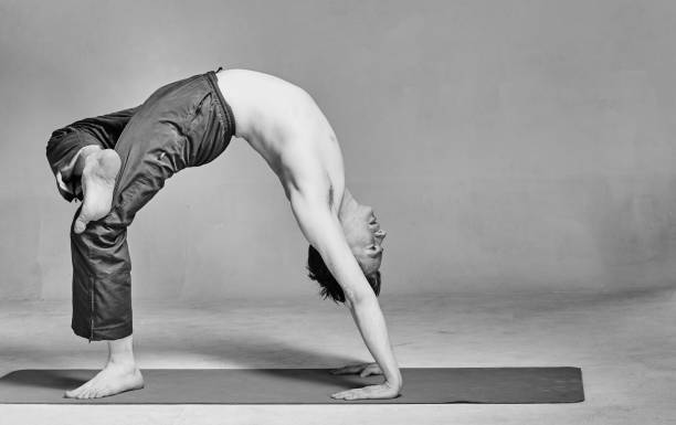istock young man is engaged in yoga in a studio 962601204