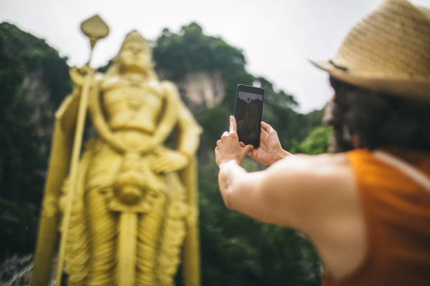 istock Woman and a breathtaking Murugan statue 962603624