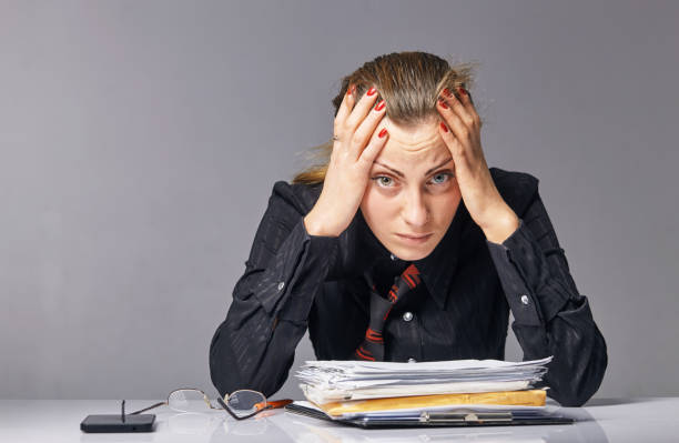 istock business woman at work. She is very tired 962603740