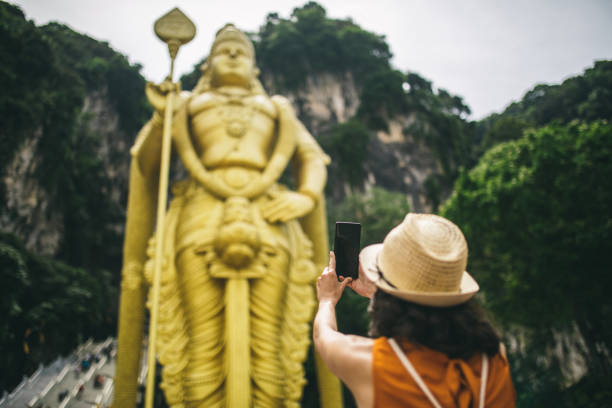 istock Woman and a breathtaking Murugan statue 962603778